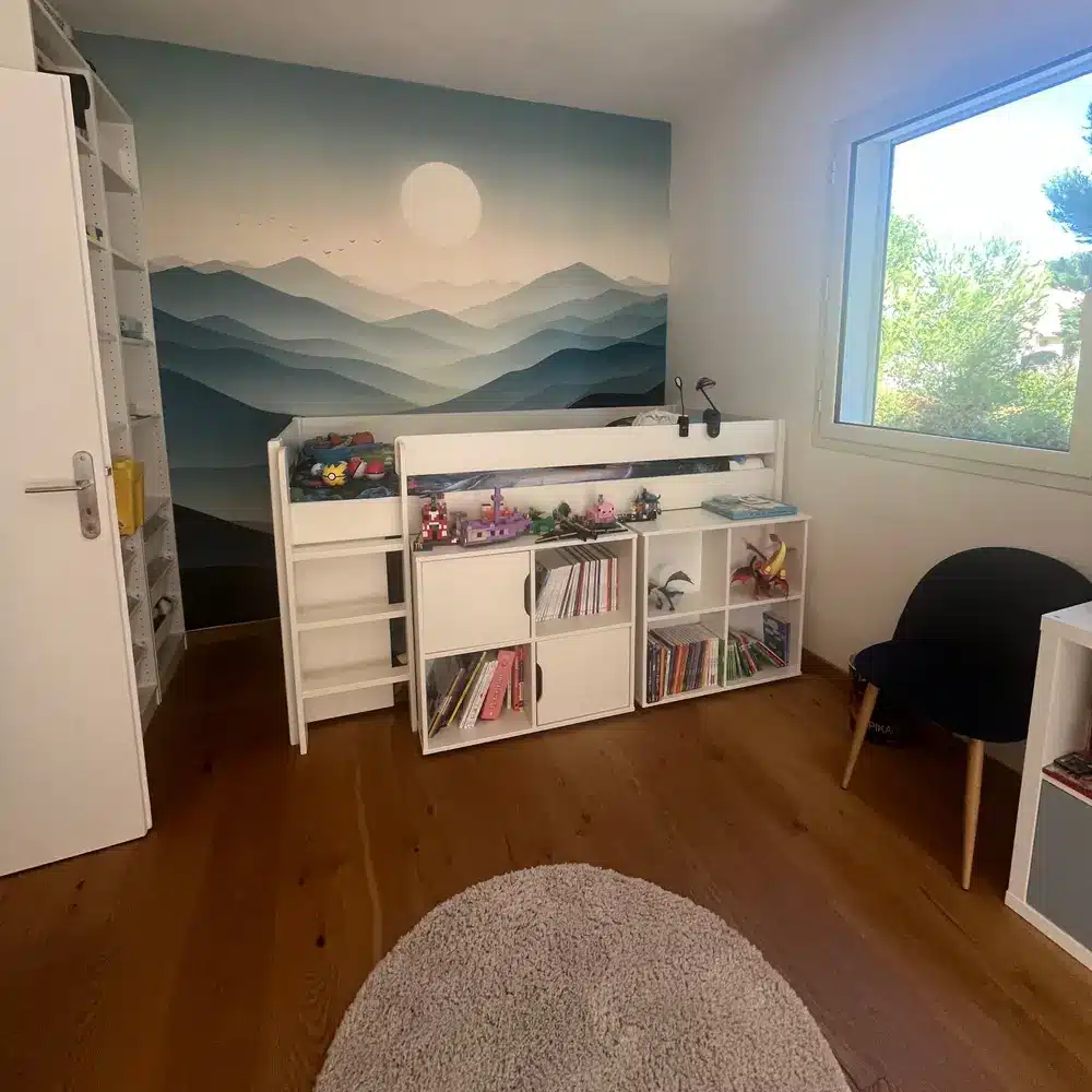 Chambre d’enfants avec lit mi-hauteur et papier peint panoramique de montagnes